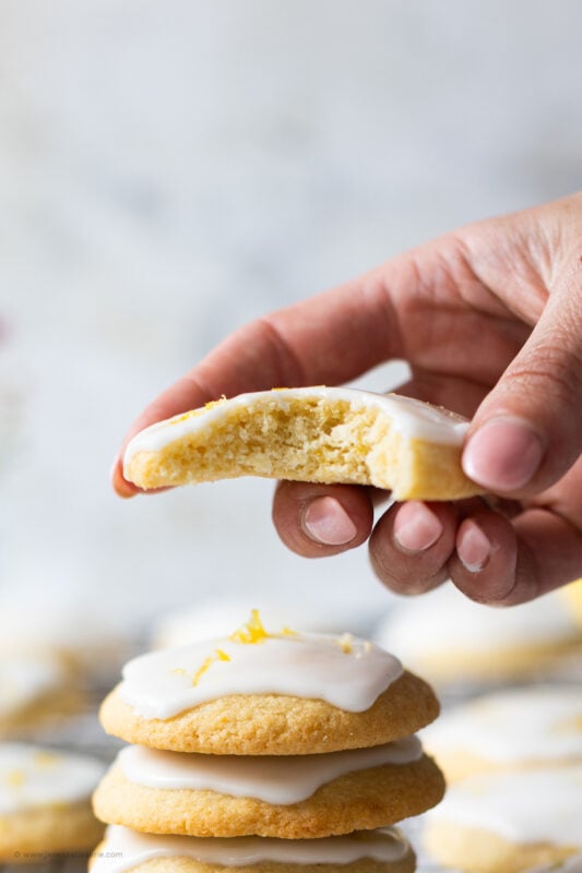 A bite taken from a glazed lemon cookie