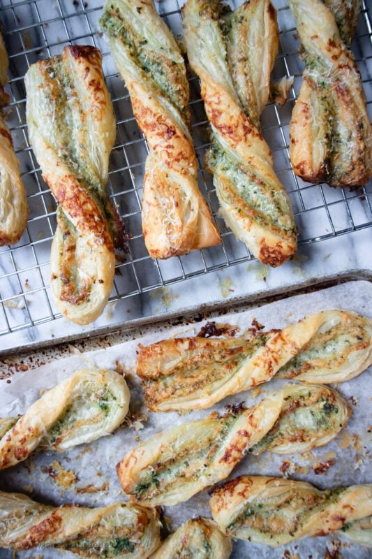 Many Pesto and Cheese Straws on a cooling rack