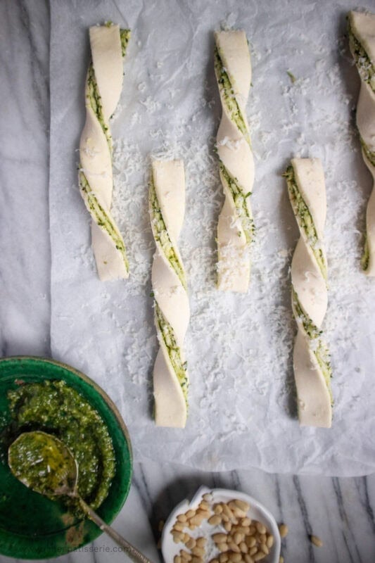 Unbaked Pesto and Cheese Straws on parchment 