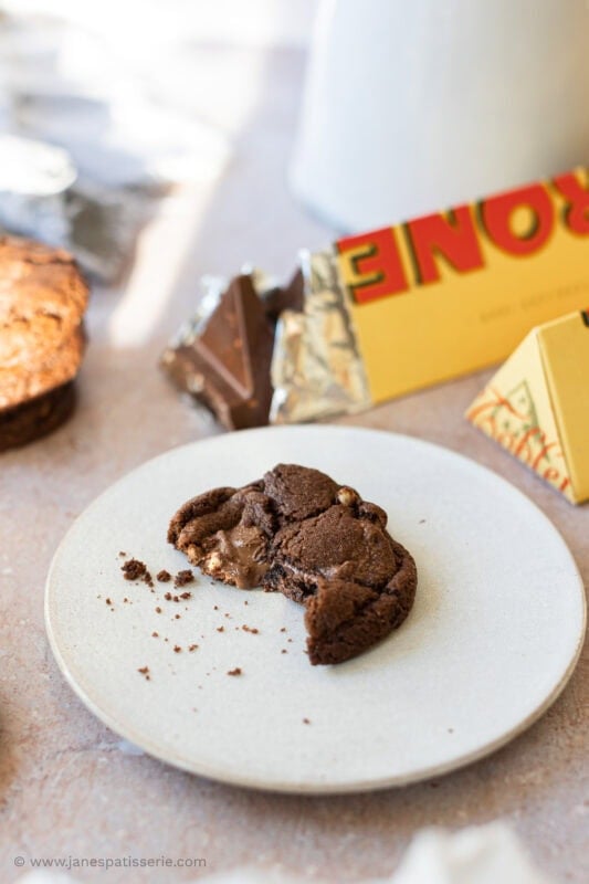 A half eaten Toblerone cookie on a plate