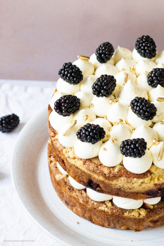 Close up, piping on apple blackberry crumble cake