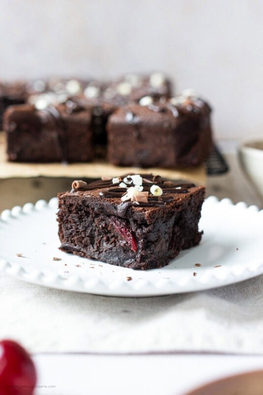 Black Forest brownie on plate with cherry visable