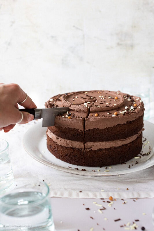 A knife cutting into back to basics chocolate cake