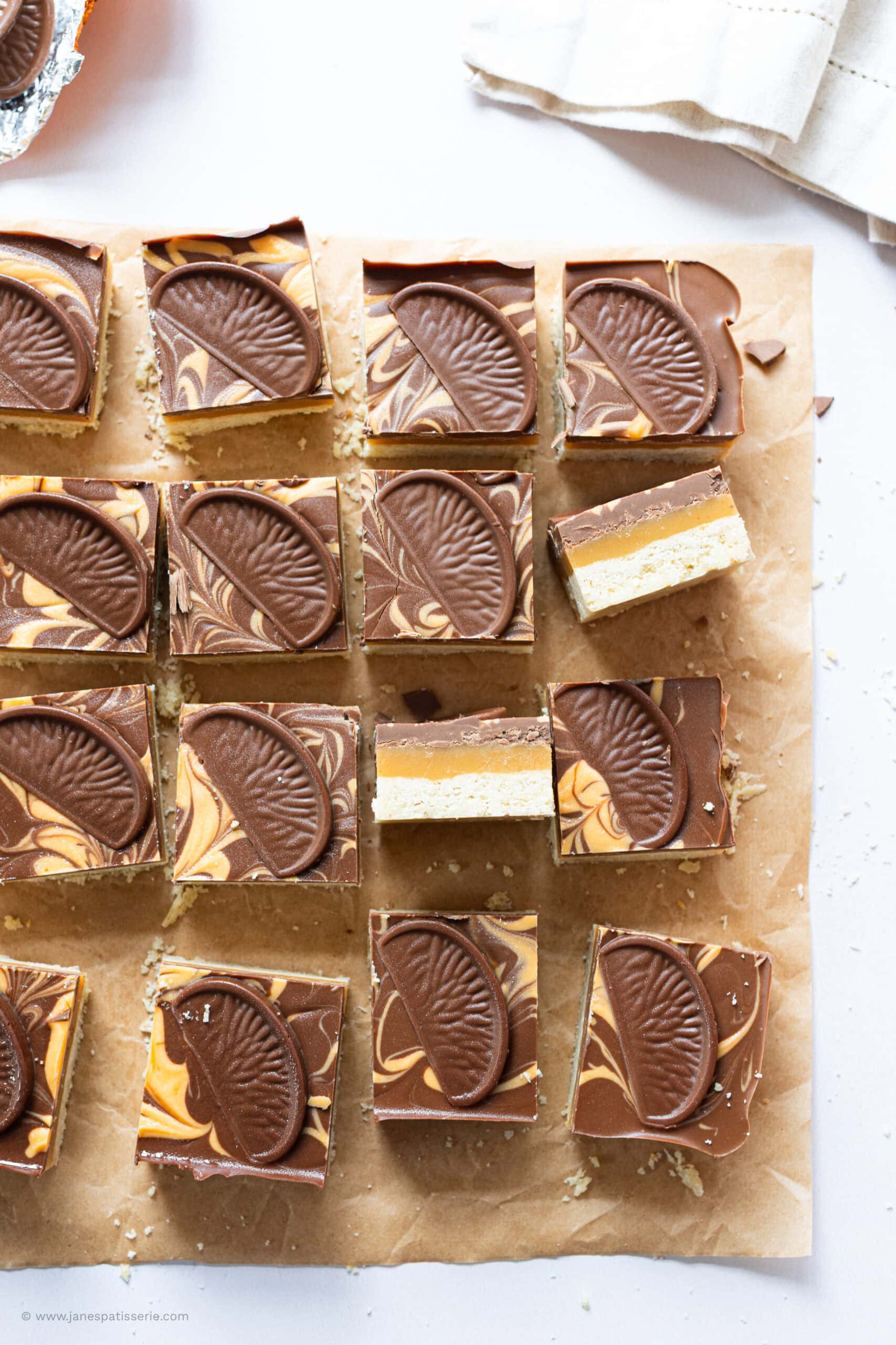 One turned on the side on a tray of Chocolate Orange Millionaires