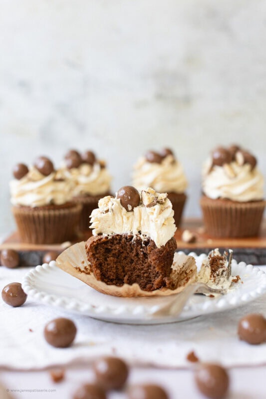 A bite taken from a malteser cupcake