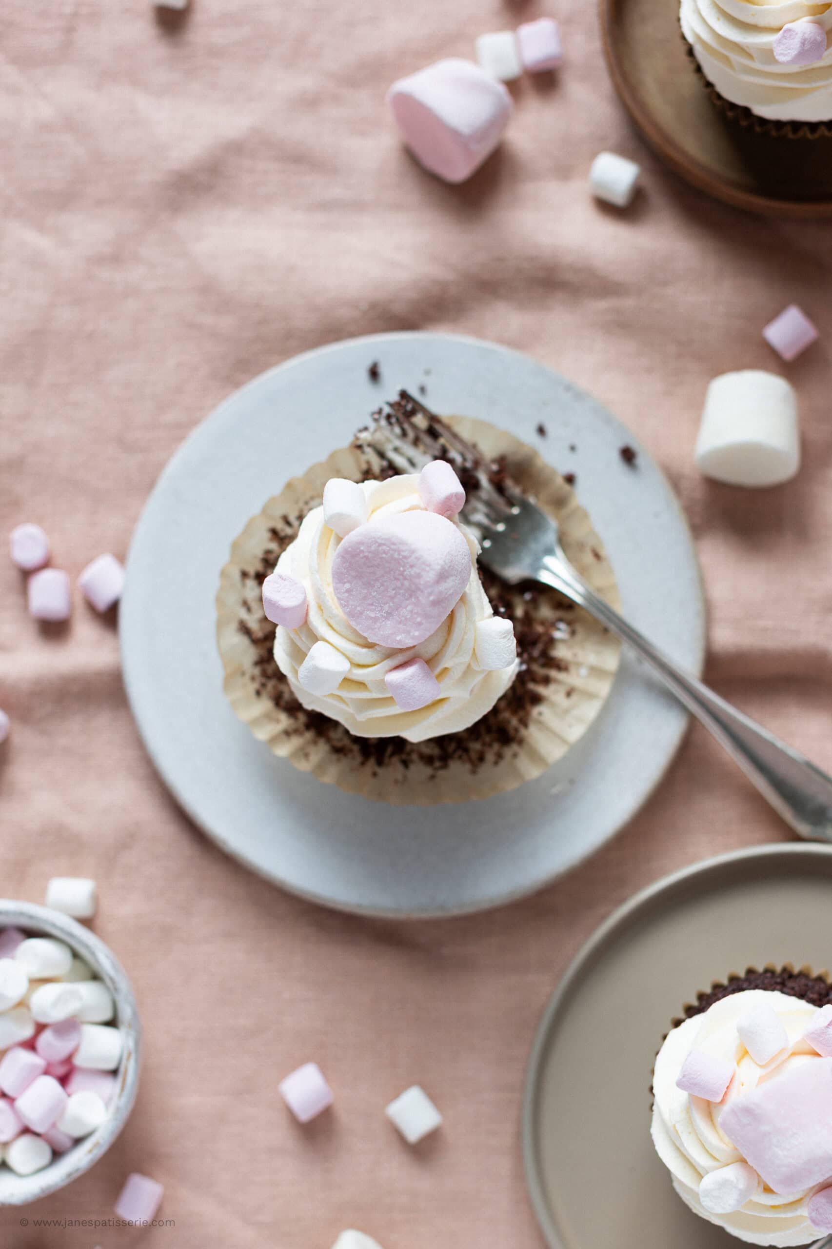 A top down shot of a marshmallow cupcake on a plate