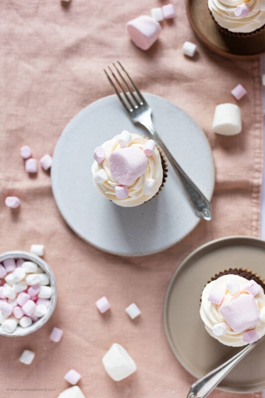 A marshmallow cupcake on a plate with a fork