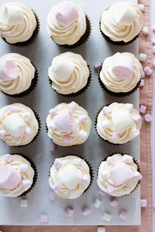 A row of marshmallow cupcakes on a baking tray