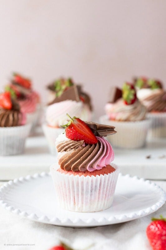 A single Neapolitan Cupcake on a white plate