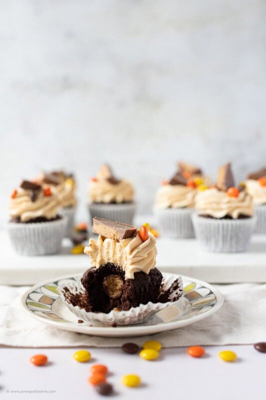 A bite missing from a Reese's Peanut Butter Cupcake