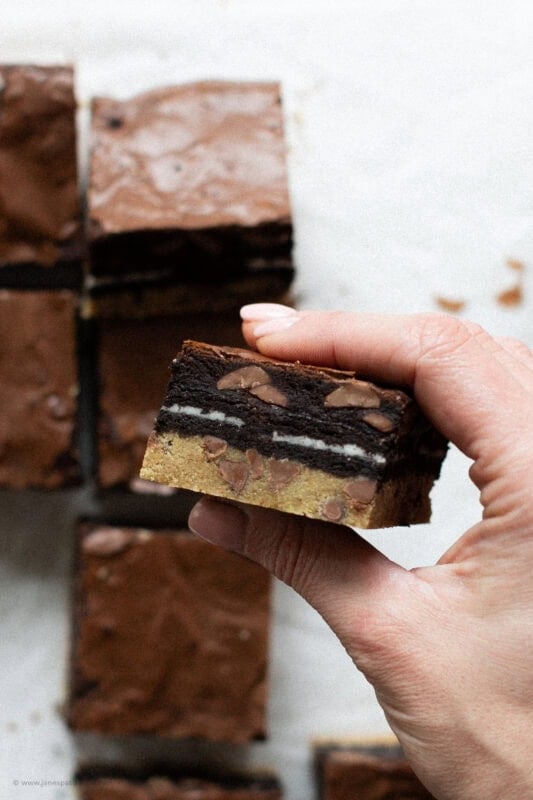 A hand holding up a Slutty brownie square