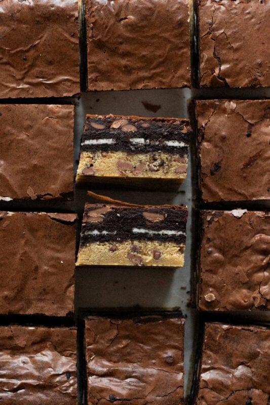 A collection of slutty brownies with two showing the cross section