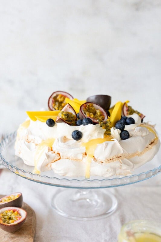 A whole Spring Pavlova on a serving stand