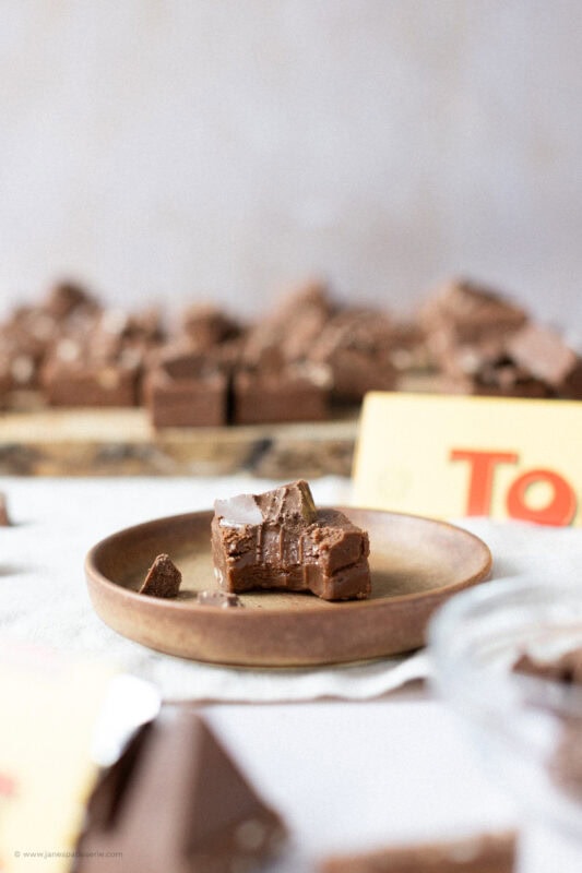 A bite taken from a square of Toblerone Fudge