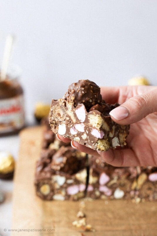 A hand holding Nutella Rocky Road at an angle