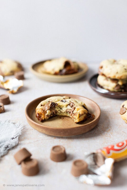 A bite missing from a Rolo Cookie on a plate