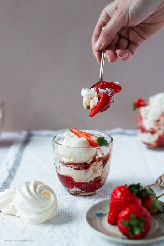 A spoon dipping into the Eton Mess with homemade meringues.