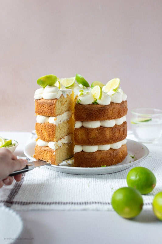 A slice being taken from a Gin and Tonic Cake