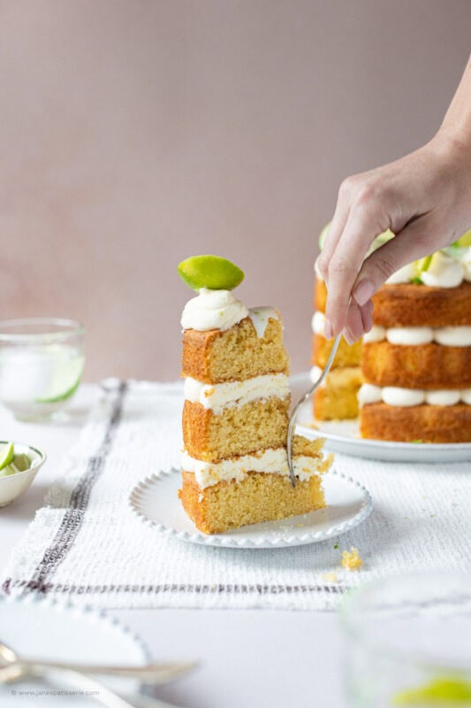 A fork cutting into a slice of gin and tonic cake