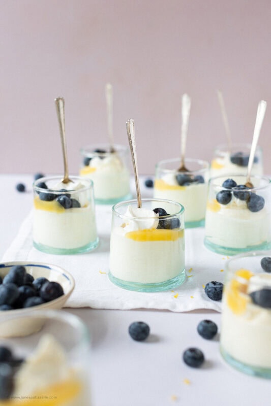 Spoons stuck into the jars of Lemon Curd Mousse