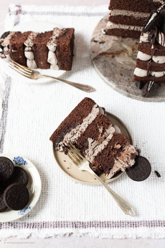 A bite taken from a slice of Oreo Cake