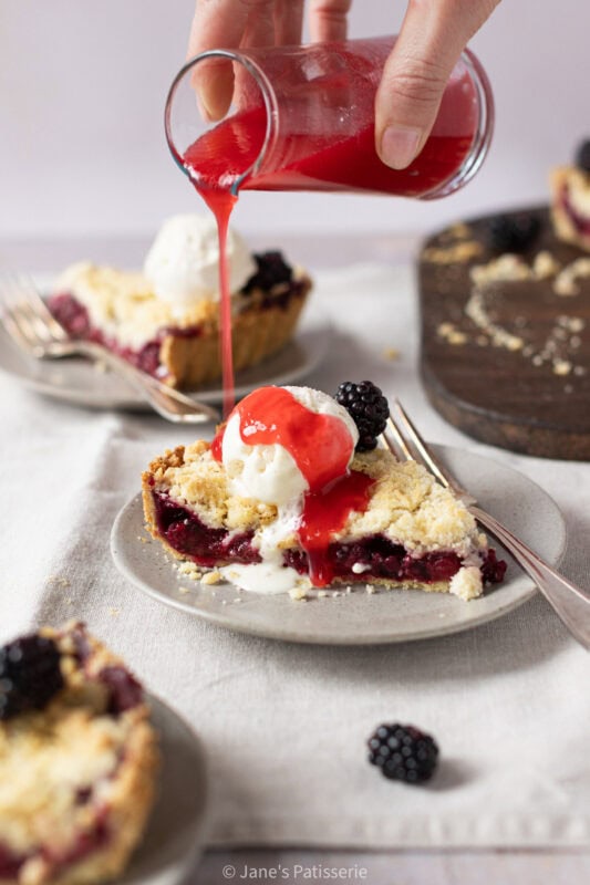 Closer shot of decorated slice of Apple and Blackberry Crumble Pie