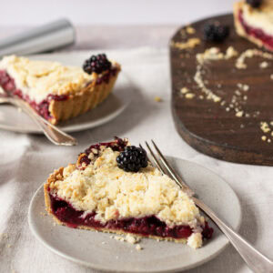 A slice of Apple and Blackberry Crumble pie on a plate