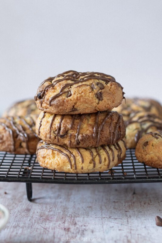 A close up of three Coconut Chocolate Rocks stacked on a cooling rack