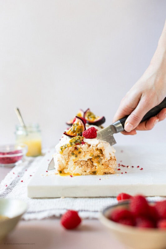 A knife cutting into the lemon meringue roulade
