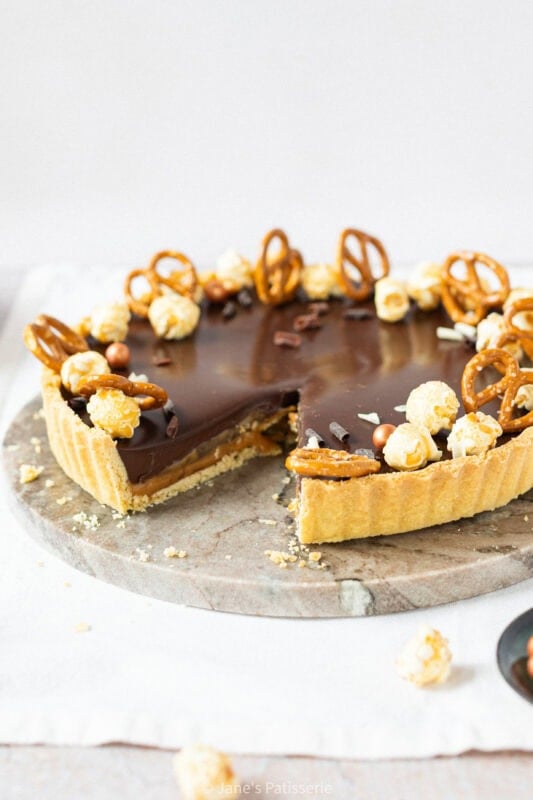 A slice missing from a Salted Caramel Tart