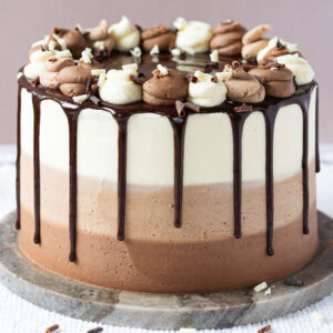 A whole triple chocolate cake on a table tray