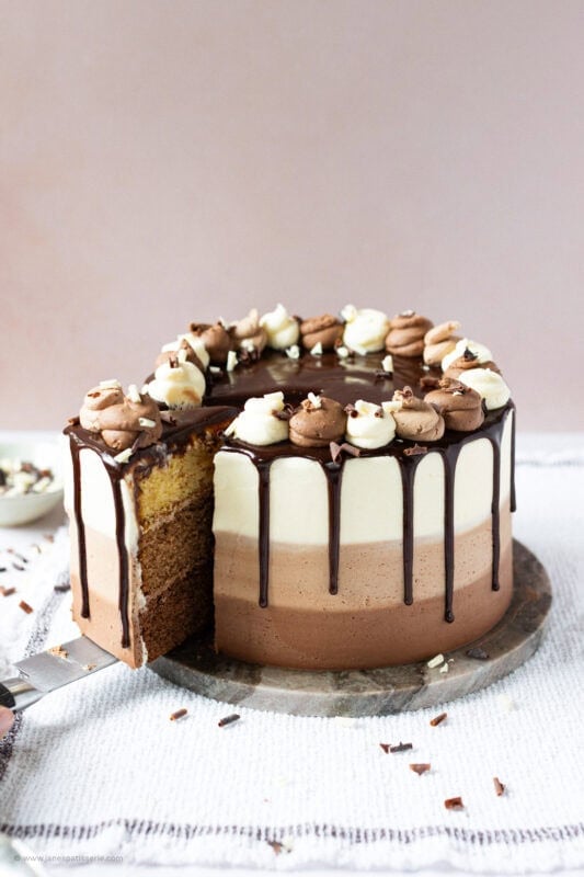 A slice being taken from a Triple Chocolate Cake