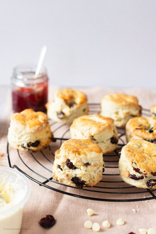 A batch of White Chocolate and Cranberry Scones on a cooling rack