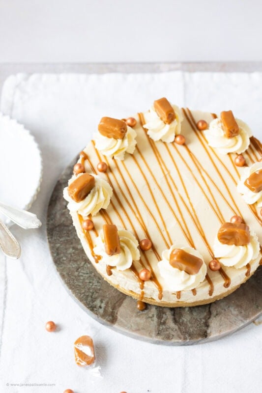 A whole Butterscotch cheesecake on a serving board