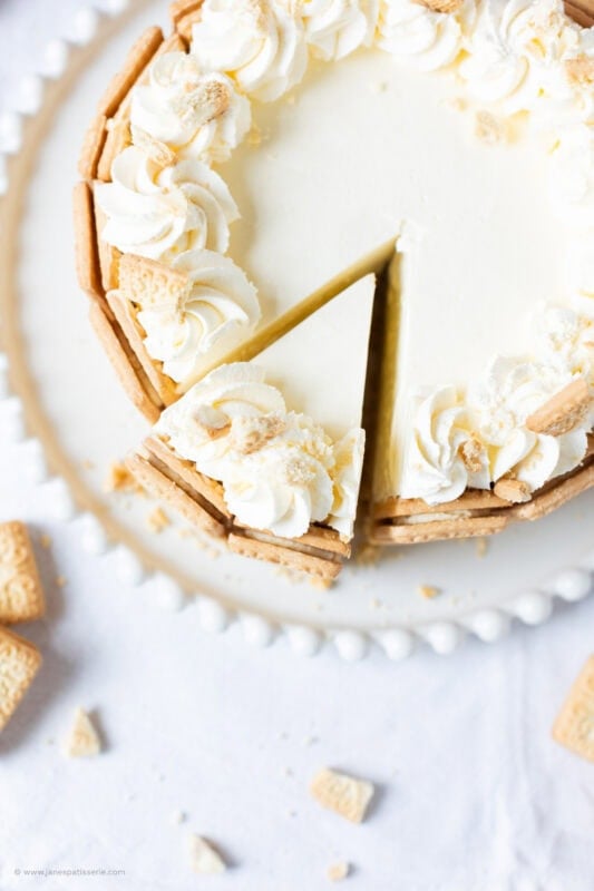 A slice cut into a whole Custard cream cheesecake