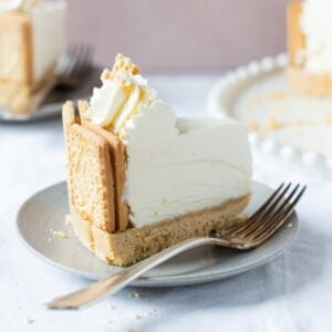 A close shot of a slice of Custard Cream Cheesecake