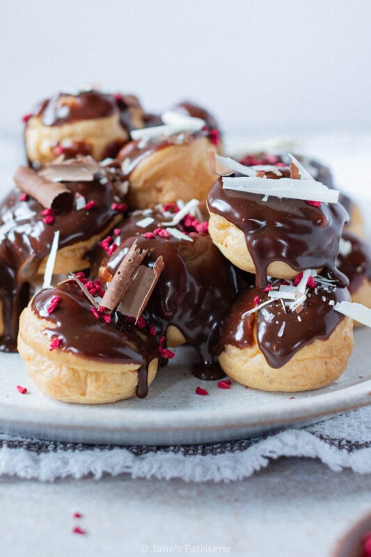 A finished batch of Profiteroles on a plate