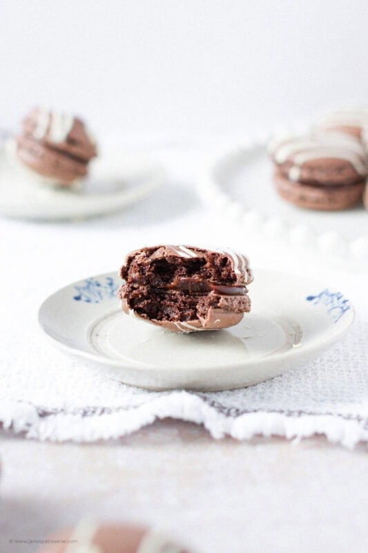 A bite missing from a Triple Chocolate Macaron