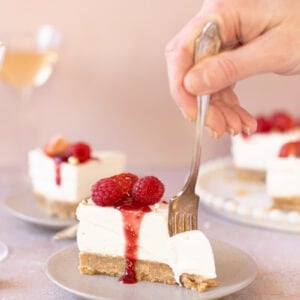 A fork slicing into a slice of Champagne Cheesecake
