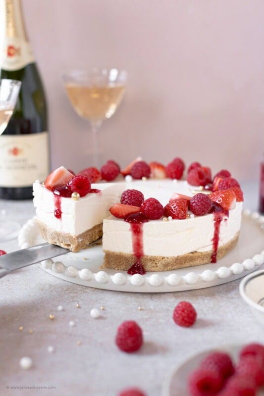 A slice being taken from a Champagne Cheesecake