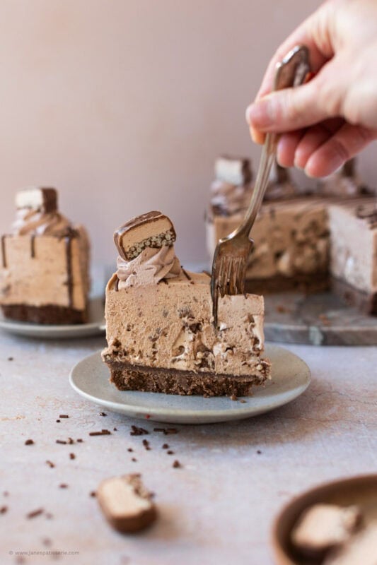 A fork cutting into the Double Decker Cheesecake slice
