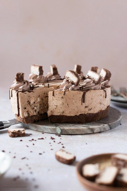 A slice being taken from a Double Decker Cheesecake