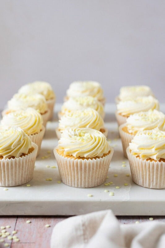A chopping board of lemon drizzle cupcakes