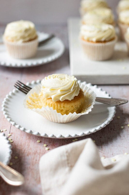 A fork cutting into an unwrapped Lemon Drizzle Cupcake