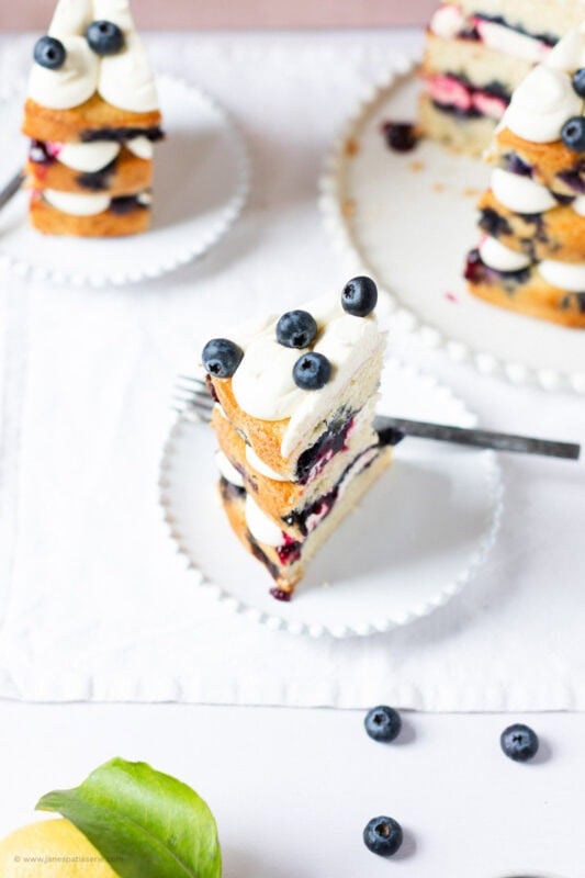 A slice of Lemon Blueberry Cake on a plate with a fork