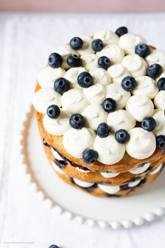 A top down shot of a fully decorated Lemon Blueberry Cake