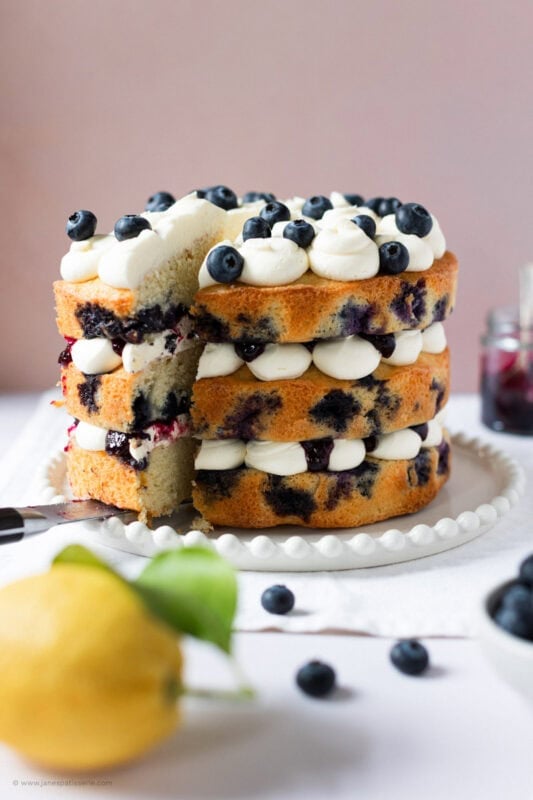 A slice being cut into a Lemon Blueberry Cake