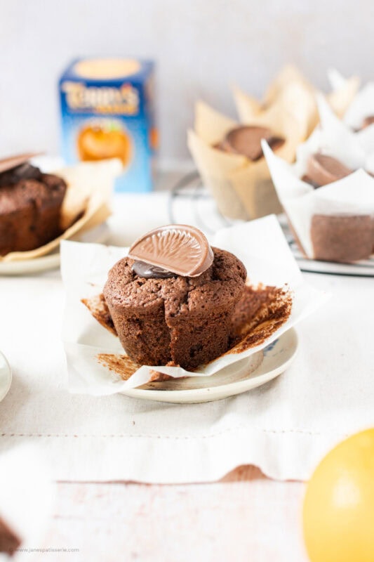 An unwrapped Chocolate Orange Muffin on a plate