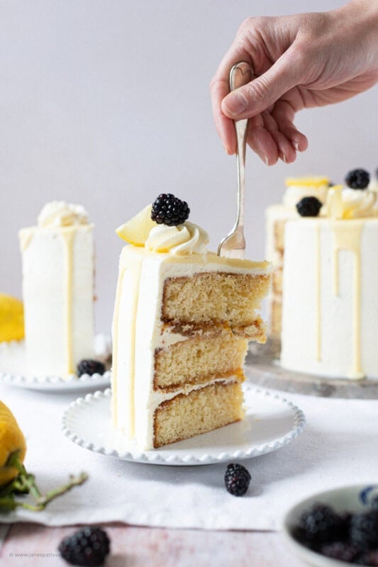A fork cutting into a slice of Lemon Elderflower Cake