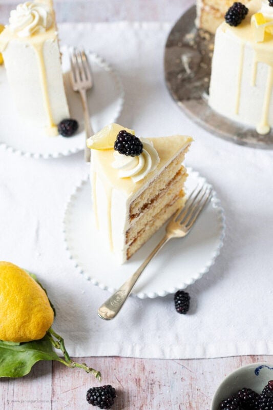 A slice of Lemon Elderflower Cake on a plate with a fork